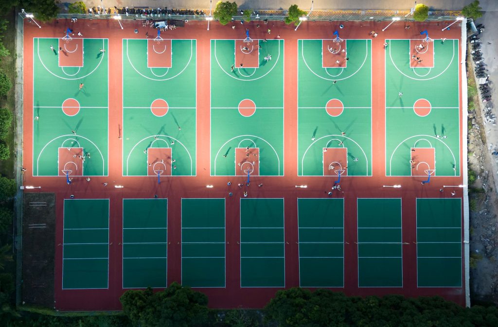 Baikon sports surface case studies: multi-court acrylic basketball and volleyball facility for community use at night