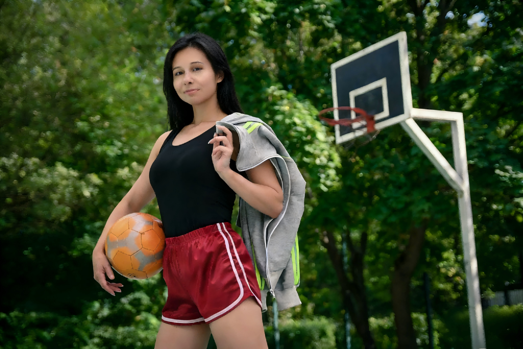 Woman with soccer ball on a multi-sport court, using our sports court surface solutions