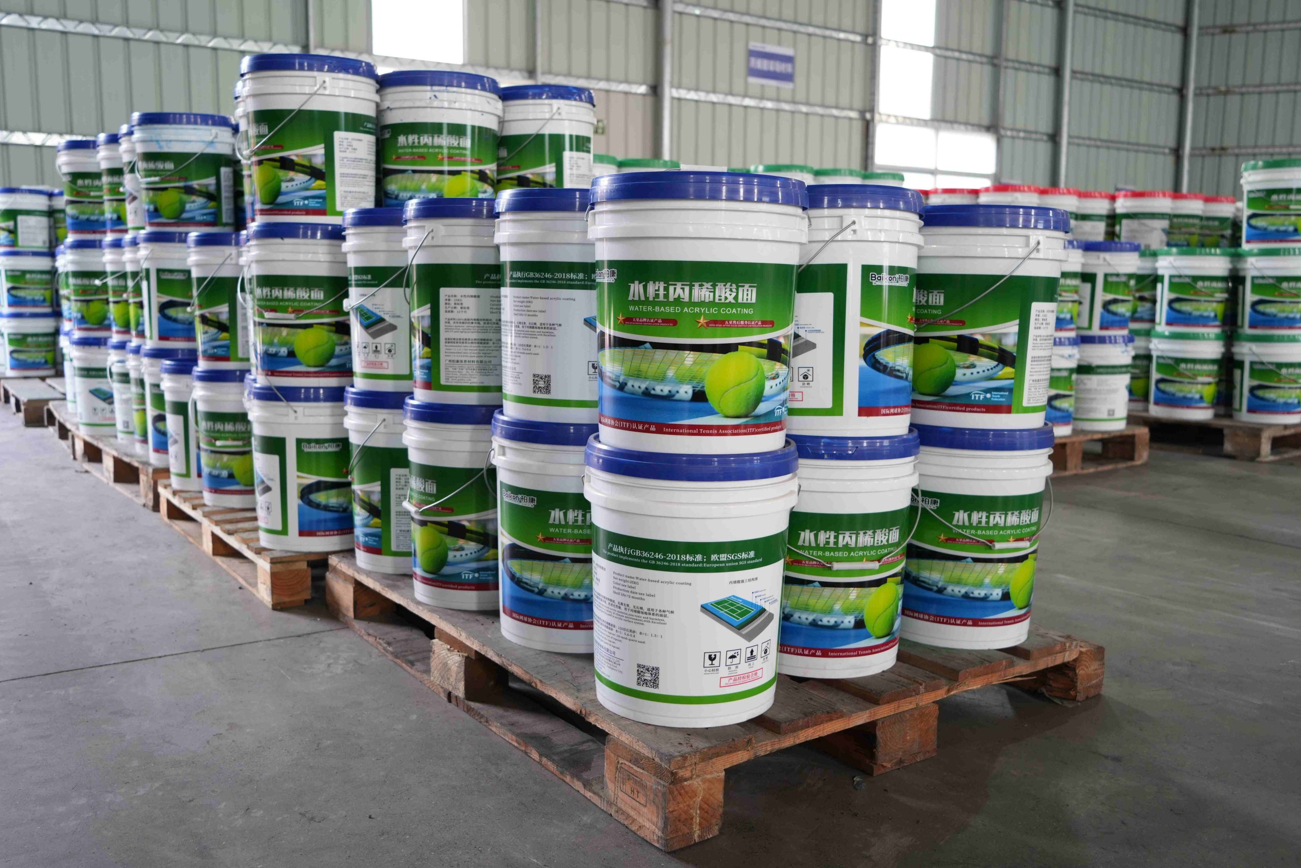 Acrylic court coating barrels at our sports court flooring manufacturer